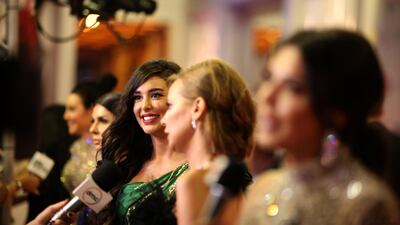 Egyptian actress Yasmine Sabri talks to reporters on the red carpet.