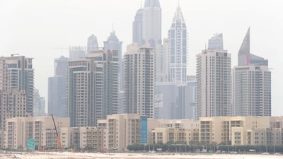 A dust storm sweeps across Dubai Marina on Saturday. Pawan Singh / The National
