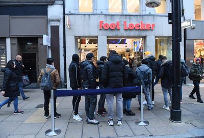 People queue up outside Foot Locker before opening during the Black Friday sales in London. EPA