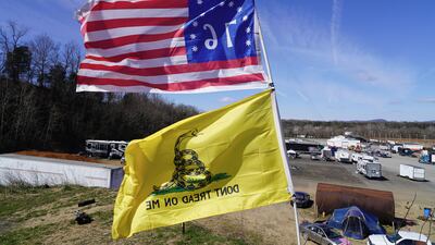 A 'Don't tread on me' flag and the Bennington flag wave in the wind above the People's Convoy in Hagerstown, Maryland. All photos: Willy Lowry / The National.