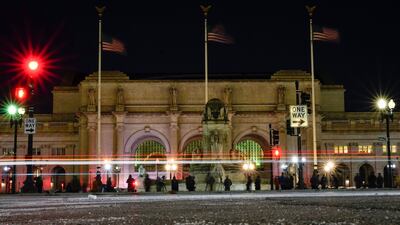 Birdwatchers set up in front of Union Station in Washington, US Friday, hoping for a glimpse of a rare snowy owl that has been flying around Washington's Capitol Hill neighbourhood. AP