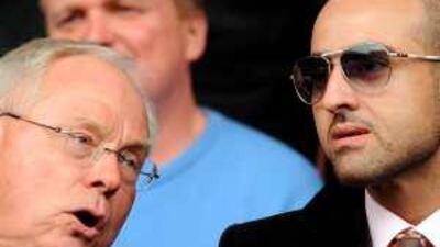 Prince Faisal, right, talks to Liverpool co-owner George Gillett in the directors' box at Anfield on Saturday.