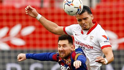 Sevilla's Karim Rekik beats Lionel Messi to a header. Reuters