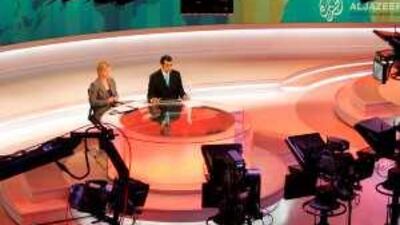 Newscasters at work at the English-language newsroom at the headquarters of the Qatar-based Al Jazeera satellite channel in Doha.