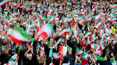 Iranian women cheer during the World Cup 2022 Group C qualification football match between Iran and Cambodia at the Azadi stadium in the capital Tehran. The Islamic republic has barred female spectators from football and other stadiums for around 40 years, with clerics arguing they must be shielded from the masculine atmosphere and sight of semi-clad men. Women fans are attending the football match freely for the first time in decades, after FIFA threatened to suspend the country over its controversial male-only policy. AFP