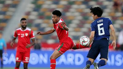 Endo Wataru of Japan and Jameel Al Yahmadi of Oman battle during the game. Chris Whiteoak / The National