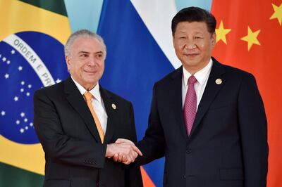 Mr Xi and Brazil President Michel Temer in South Africa. AFP