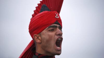 An Indian army recruit wearing his ceremonial uniform shouts a command during the passing-out parade at a garrison in Rangreth on the outskirts of Srinagar. Danish Ismail / Reuters