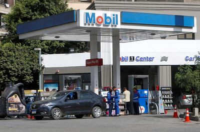 Employees fill vehicles at a Mobil petrol station in Cairo, Egypt. Reuters