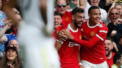 Manchester United's midfielder Bruno Fernandes celebrates scoring his team's first goal with Mason Greenwood during the match against Leeds United at Old Trafford on Saturday, August 14, 2021.