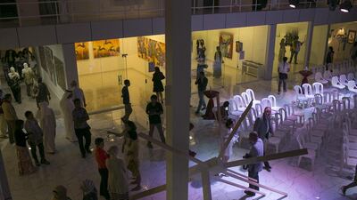 Guests peruse the artwork on display during the opening for the Philippine Art Month.