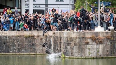 The statue of 17th century slave trader Edward Colston falls into the water after protesters pulled it down and pushed into the docks, during a protest against racial inequality in Bristol, UK, June 7. Keir Gravil / Reuters