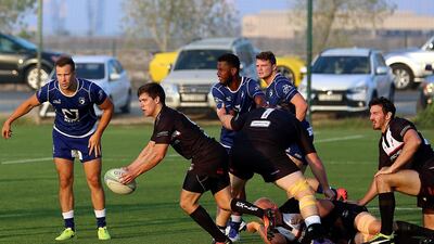Jebel Ali Dragons, in blue, and Dubai Exiles, in black, are among the UAE rugby clubs striving for sponsorship. Satish Kumar for the National