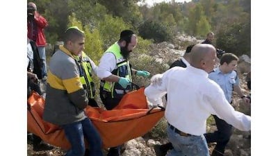 Israeli medics and volunteers carry the body of the American Christine Logan yesterday. Menahem Kahana / AFP