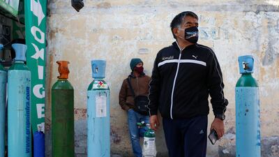 Jorge Perez lines up to refill an oxygen tank for a family member sick with Covid-19 in Mexico City. AP Photo