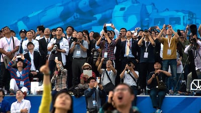 Spectators watch the Airshow China 2014 in Zhuhai, south China's Guangdong province on November 12, 2014. Johannes Eisele / AFP