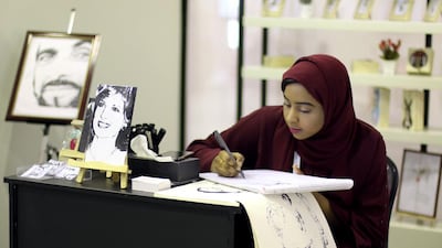 Teenage pop artist Shamma Al Semihi puts pen to paper at the annual Zero Nine Exhibition in Fujairah. Courtesy Zero Nine