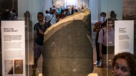 The Rosetta Stone at the British Museum in London. It is inscribed in two languages using three scripts. AFP