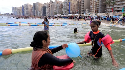 Farah swims with her sister at Al Mandara beach. Reuters