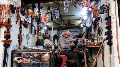 A craftsman sits in a workshop fashioning leather holsters in the Hamada market of the Karkh district in the centre of Iraq's capital Baghdad. AFP