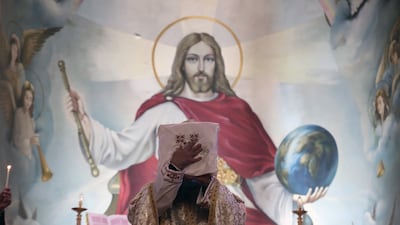 A priest prays during Coptic Orthodox Christmas Mass at the Archangel Michael Coptic Orthodox Church in Cairo, Egypt. EPA