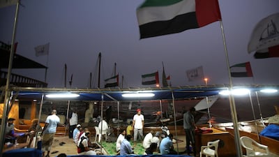 Ssailors socialise after their evening prayer a day ahead of the Al Gaffal traditional Dhow Race. Kamran Jebreili / AP Photo