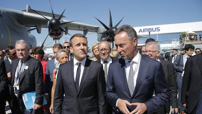 Emmanuel Macron, centre, at the Paris Air Show with the president and chief executive of Airbus, Fabrice Bregier. Michel Euler / EPA