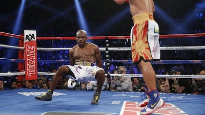 Timothy Bradley falls to the mat after getting hit by Manny Pacquiao, of the Philippines, during their WBO welterweight boxing bout Saturday, April 9, 2016, in Las Vegas. (AP Photo/John Locher)