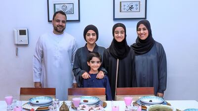Fathima Mansoor Ahmed, right, brings her time growing up in South Africa to her dishes during iftar with her family, from left, Maseeh, Maryam, Zahraa and, front, Muhammad, to keep things fresh and healthy Victor Besa / The National