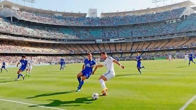 Everton defender Phil Jagielka, centre left, closes down the Real Madrid forward Cristiano Ronaldo during the first football game ever to be played at Dodger Stadium in Los Angeles. Kevork Djansezian / Getty Images