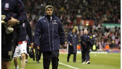 The Spurs manager Juande Ramos, centre, looks dejected after watching his side lose yet another game at Stoke.