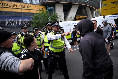 Police officers and protestors outside the Britannia hotel in Canary Wharf which is used to accommodate asylum seekers. AFP