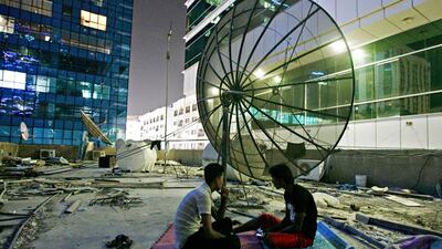 The roof of the compound is covered with construction debris, old water tanks, television dishes and thousands of cigarette ends.