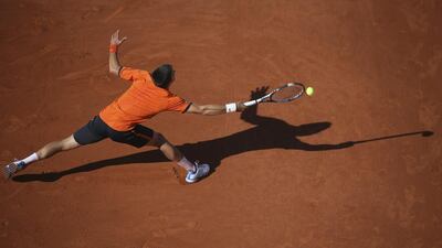 Serbia's Novak Djokovic returns in the men's final of the French Open tennis tournament against Switzerland's Stan Wawrinka at the Roland Garros stadium, in Paris, France, Sunday, June 7, 2015. (AP Photo/David Vincent)