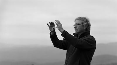 A man stands at the edge of the hill, seemingly about to take a landscape photograph. Courtesy Eric Pickersgill
