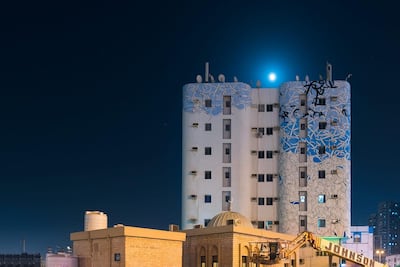 Legibility isn't a priority in El Seed's works (the work pictured is in Ajman). "I want people to reflect on what they are looking at," he told The National earlier this year. "It's super-difficult to read what I write, but if you read Arabic, you will know."