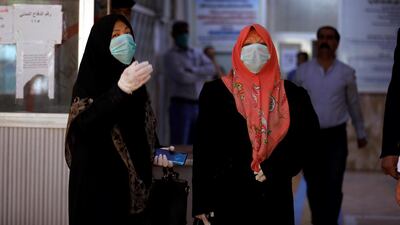 Iraqi women who have recovered from the coronavirus wear protective face masks as they leave the quarantine hospital, following the outbreak of the virus, in Baghdad, Iraq March 9, 2020. Reuters