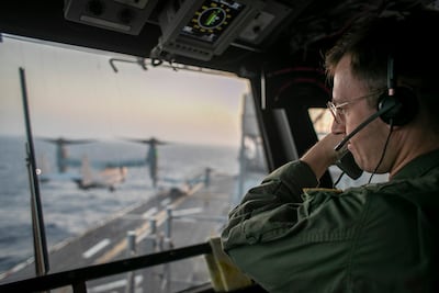 A naval officer aboard the USS Tripoli in the Arabian Sea oversees flight operations from the control tower. Photo: Centcom