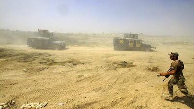 Iraqi security forces advance their positions during the fight against Islamic State militants in Fallujah. Anmar Khalil / AP