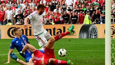 Iceland defender Birkir Saevarsson scores the late own goal that handed Hungary a point that puts them on the verge of qualifying for the knockout stages. Attila Kisbendek / AFP