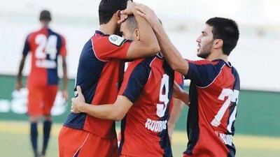 Al Shaab players celebrate a goal against Dibba Al Fujairah. Al Itihad