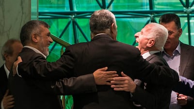 Palestinian member of Fatah Central Committee, Azam Al Ahmed, right, Hamas official Saleh Al Aruri, left, and Egyptian intelligence minister Khalid Fawzi during the signing ceremony in Cairo. EPA