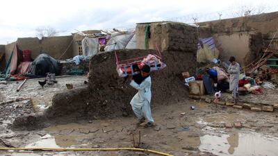 People salvage their belongings after flash floods in Kandahar, Afghanistan on March 2, 2019. EPA
