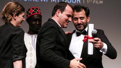 Hungarian director Kornel Mundruczo, centre, receives the top prize for his movie Feher Isten (White God) from Jury President and Argentine director Pablo Trapero, right, during the Un Certain Regard Closing Award Ceremony during the 67th annual Cannes Film Festival on May 23, 2014. Julien Warnand / EPA