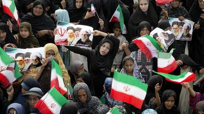 A supporter of Iranian president Hassan Rouhani holds a poster at a gathering at Chabahar grand stadium in Sistan and Baluchestan Province on south-eastern Iran. Maryam Rahmanian for The National