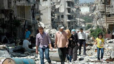 Hundreds of displaced residents returned to inspect the damge to their homes and possessions after rebels vacated areas of the Old City of Homs under a deal with the Bashar Al Assad governmment. AFP / May 10, 2014