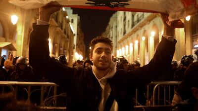 A Lebanese protester waves a national flag during a demonstration near the parliament. AFP