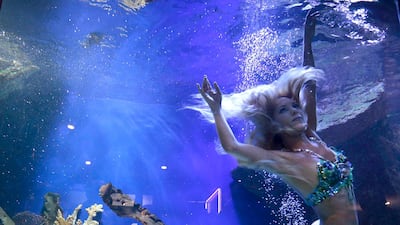 Model Hannah Fraser dressed as a mermaid swins in an aquarium to promote the film "Tears of a Mermaid". Eric Gaillard / Reuters