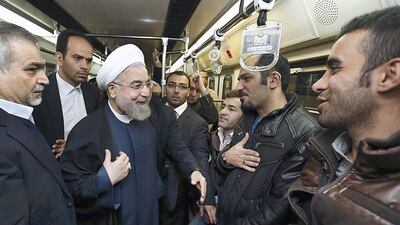 Iran's president Hassan Rouhani speaks with people onboard a subway in Tehran on January 19. AP Photo/Iranian Presidency Office