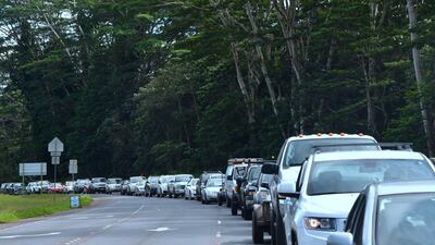 Vehicles head for the intersection of Pahoa and Kapoho Roads as evacuees are allowed to return to their Leilani Estates homes to gather belongings and exit on May 6, 2018, in Pahoa, Hawaii. Frederic Brown / AFP